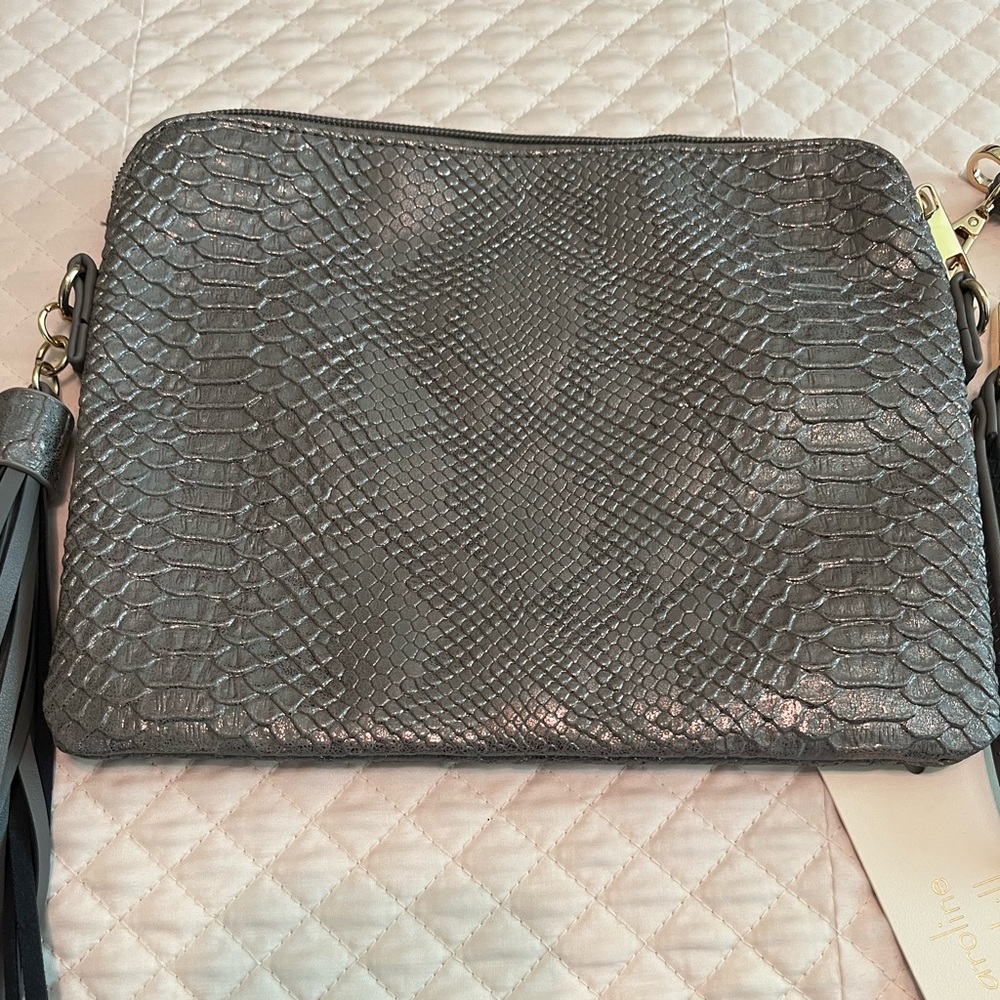 NWT clutch bag with wrist and shoulder straps. Measures 10” X 8”